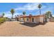 Spacious backyard with desert landscaping and a covered patio area at 1158 E Hacienda Ave, Las Vegas, NV 89119