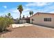 Large backyard featuring gravel landscaping, a storage shed, and mature palm trees at 1158 E Hacienda Ave, Las Vegas, NV 89119