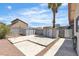 Backyard featuring gravel landscaping, a concrete patio area, a block wall and two storage sheds at 1158 E Hacienda Ave, Las Vegas, NV 89119