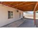 A covered patio with exterior view with adjacent rock landscaping and privacy wall at 1158 E Hacienda Ave, Las Vegas, NV 89119