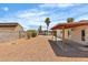 Backyard features gravel landscaping, a covered patio, block wall, and a palm tree at 1158 E Hacienda Ave, Las Vegas, NV 89119