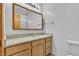 Bathroom featuring single vanity with a bright mirror and a separate toilet at 1158 E Hacienda Ave, Las Vegas, NV 89119