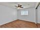 Bedroom with ceiling fan, hardwood floors, and a large sliding glass door closet at 1158 E Hacienda Ave, Las Vegas, NV 89119