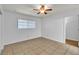White bedroom features tile flooring, and ceiling fan with light at 1158 E Hacienda Ave, Las Vegas, NV 89119