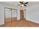Bedroom featuring ceiling fan, hardwood floors, and a sliding glass door closet at 1158 E Hacienda Ave, Las Vegas, NV 89119
