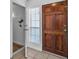 Entryway featuring tile floors, a wood door, and a window with blinds at 1158 E Hacienda Ave, Las Vegas, NV 89119