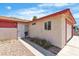 Side view of a single-story home featuring desert landscaping and a beige and red exterior at 1158 E Hacienda Ave, Las Vegas, NV 89119