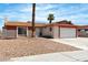Single-story home featuring desert landscaping and a beige and red exterior paint scheme at 1158 E Hacienda Ave, Las Vegas, NV 89119