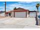 Single-story home featuring a two-car garage, desert landscaping, and a white exterior at 1158 E Hacienda Ave, Las Vegas, NV 89119