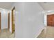 Neutral hallway featuring tile flooring, light walls, and various entryways into other rooms at 1158 E Hacienda Ave, Las Vegas, NV 89119
