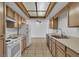 Traditional-style kitchen featuring light wood cabinets, white appliances, and tile floors at 1158 E Hacienda Ave, Las Vegas, NV 89119