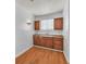 Bright laundry area features wood cabinets, sink, wood floors, and window for natural light at 1158 E Hacienda Ave, Las Vegas, NV 89119