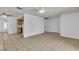Open living room with tile floors, ceiling fans, and access to the kitchen area at 1158 E Hacienda Ave, Las Vegas, NV 89119