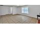 Clean living room with neutral tile floors, natural light, and direct access to the entryway at 1158 E Hacienda Ave, Las Vegas, NV 89119