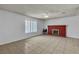 Bright living room featuring a classic red brick fireplace and neutral tile flooring at 1158 E Hacienda Ave, Las Vegas, NV 89119
