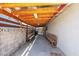 Covered patio with wooden beams, concrete flooring, and built-in wooden benches along the wall at 1158 E Hacienda Ave, Las Vegas, NV 89119
