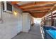 Covered patio features concrete floor, wooden beams, a storage cabinet, and built-in benches at 1158 E Hacienda Ave, Las Vegas, NV 89119
