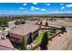 Aerial showcasing home with backyard, mature trees, well-kept landscaping, neighborhood, and desert landscape in the distance at 1182 Thomas Bay Cir, Logandale, NV 89021