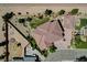 Desert home features a unique roof, detached garage, long driveway, and mature desert landscaping at 1182 Thomas Bay Cir, Logandale, NV 89021