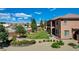 Beautiful backyard with green lawn, custom stone fire pit, and desert landscaping at 1182 Thomas Bay Cir, Logandale, NV 89021