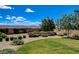 Backyard features a circular firepit area, mature trees, and desert landscaping at 1182 Thomas Bay Cir, Logandale, NV 89021