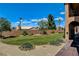 Expansive backyard featuring lush green lawn, desert landscaping, and mature trees, perfect for outdoor living at 1182 Thomas Bay Cir, Logandale, NV 89021