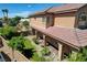 Spacious backyard with lush lawn, manicured shrubs, and a covered patio area at 1182 Thomas Bay Cir, Logandale, NV 89021