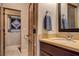 Cozy bathroom with a dark wood vanity, decorative mirror, and unique wall decor at 1182 Thomas Bay Cir, Logandale, NV 89021