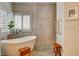 Bright and airy bathroom featuring a soaking tub and stylish window shutters at 1182 Thomas Bay Cir, Logandale, NV 89021
