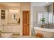 Bright bathroom boasts a soaking tub and a large vanity with beautiful marble countertops at 1182 Thomas Bay Cir, Logandale, NV 89021