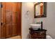 Charming powder room featuring vessel sink atop a dark wood cabinet at 1182 Thomas Bay Cir, Logandale, NV 89021