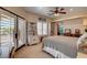 Comfortable bedroom with plantation shutters, ceiling fan, and attached bathroom at 1182 Thomas Bay Cir, Logandale, NV 89021