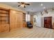 Spacious bonus room features built-in cabinets and shelves, a Murphy bed, a refrigerator, and vinyl plank floors at 1182 Thomas Bay Cir, Logandale, NV 89021