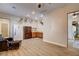 A spacious bonus room features a refrigerator, wet bar, leather chair, and hardwood-style flooring at 1182 Thomas Bay Cir, Logandale, NV 89021