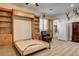 Bonus room showcases a Murphy bed, custom cabinets, and shelving, along with a convenient mini-fridge at 1182 Thomas Bay Cir, Logandale, NV 89021