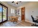 Bright dining area features a wooden table, chairs, built-in bookshelf, and door to the outdoor patio at 1182 Thomas Bay Cir, Logandale, NV 89021