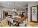 Large dining room with modern chandelier, tile floors, and access to kitchen and living areas at 1182 Thomas Bay Cir, Logandale, NV 89021