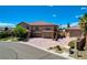 Beautiful home with a long driveway, well-manicured lawn, and lush landscaping at 1182 Thomas Bay Cir, Logandale, NV 89021