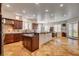 Open-concept kitchen with granite countertops, custom cabinets, and tile flooring at 1182 Thomas Bay Cir, Logandale, NV 89021
