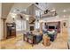 Open-concept living room with a fireplace, high ceilings, and plenty of natural light at 1182 Thomas Bay Cir, Logandale, NV 89021