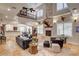 Bright, open-concept living room features tile floors, a fireplace, and a second-story balcony at 1182 Thomas Bay Cir, Logandale, NV 89021