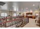 Spacious loft featuring a wooden and wrought iron railing, built-in cabinets, and natural light, perfect for versatile living at 1182 Thomas Bay Cir, Logandale, NV 89021