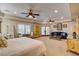 Inviting main bedroom with dual ceiling fans, plantation shutters, and ample seating for a cozy and relaxing atmosphere at 1182 Thomas Bay Cir, Logandale, NV 89021