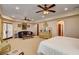 Bright and airy main bedroom featuring plantation shutters, a comfortable sitting area, and an elegant decor style at 1182 Thomas Bay Cir, Logandale, NV 89021