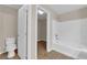 Bathroom featuring a toilet, and a shower-tub combo, with a doorway to a walk-in closet at 125 Sharp Edge Ave, North Las Vegas, NV 89031