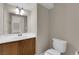 Bathroom with a vanity, sink, and standard toilet with white fixtures at 125 Sharp Edge Ave, North Las Vegas, NV 89031