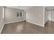 Spacious bedroom featuring wood-look floors, a window, baseboard trim, and neutral walls at 125 Sharp Edge Ave, North Las Vegas, NV 89031