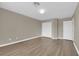 Bedroom with wood-look floors, neutral walls, and double door closet at 125 Sharp Edge Ave, North Las Vegas, NV 89031