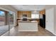Bright kitchen with island, granite countertops, and a sliding door to the backyard at 125 Sharp Edge Ave, North Las Vegas, NV 89031