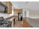 Spacious kitchen with stone countertops, stainless steel sink, and black appliances at 125 Sharp Edge Ave, North Las Vegas, NV 89031